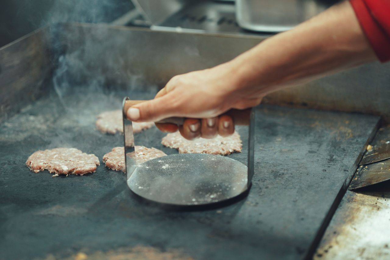 Chef preparing cheesesteaks on the grill